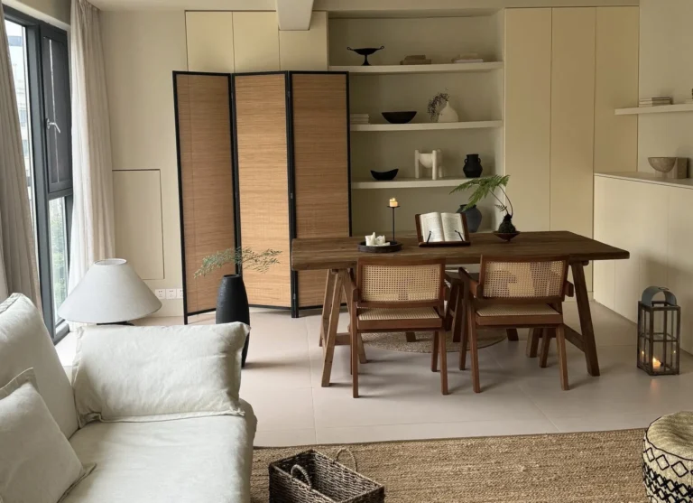 Modern living room with bamboo furniture, eco-friendly TV cabinet, floating shelves, black sofa, and minimalist farmhouse design for sustainable home decor.