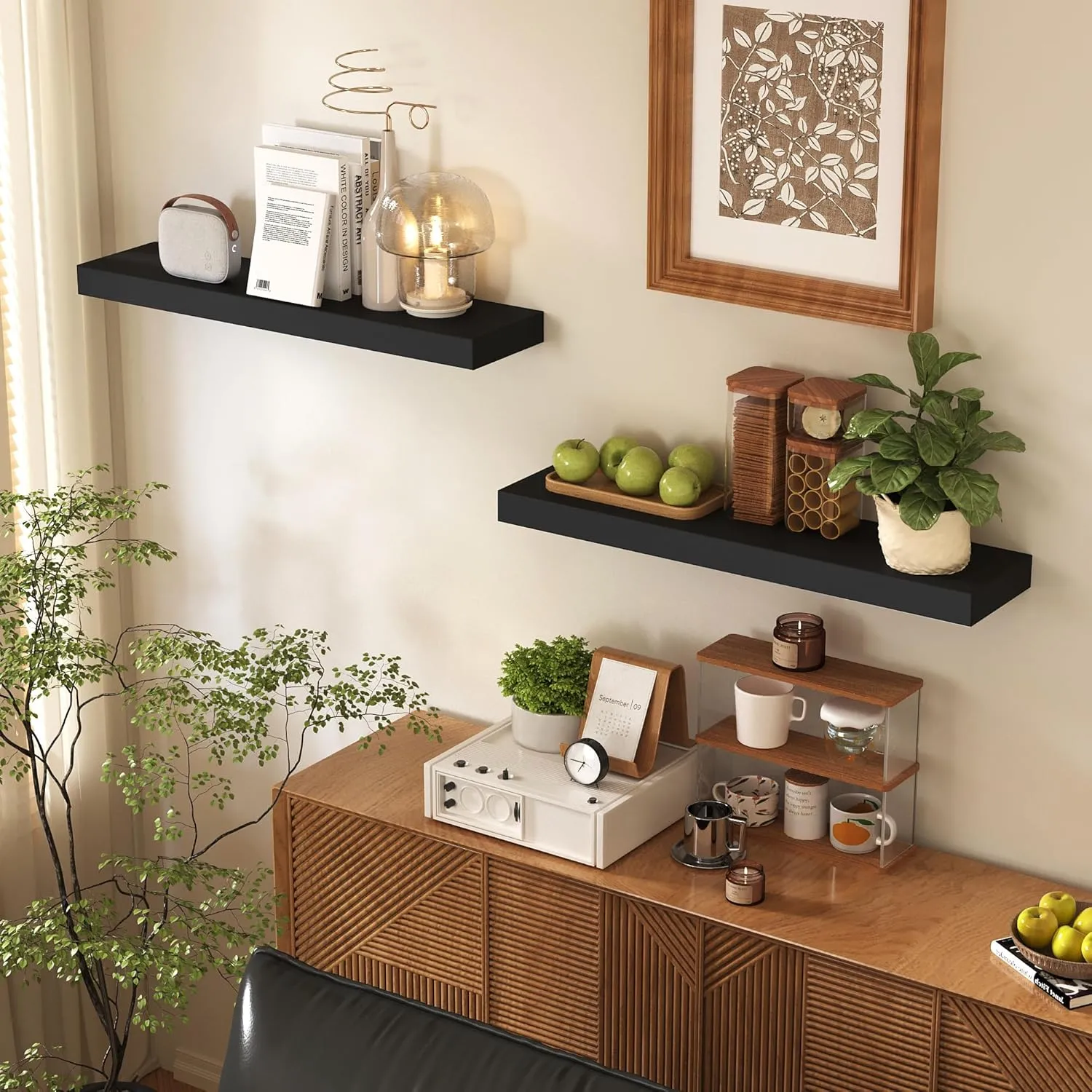 Minimalist black floating shelves mounted securely above a cabinet in a modern living room, serving as the best shelves for an organized display of books, lamps, and seasonal gallery items.