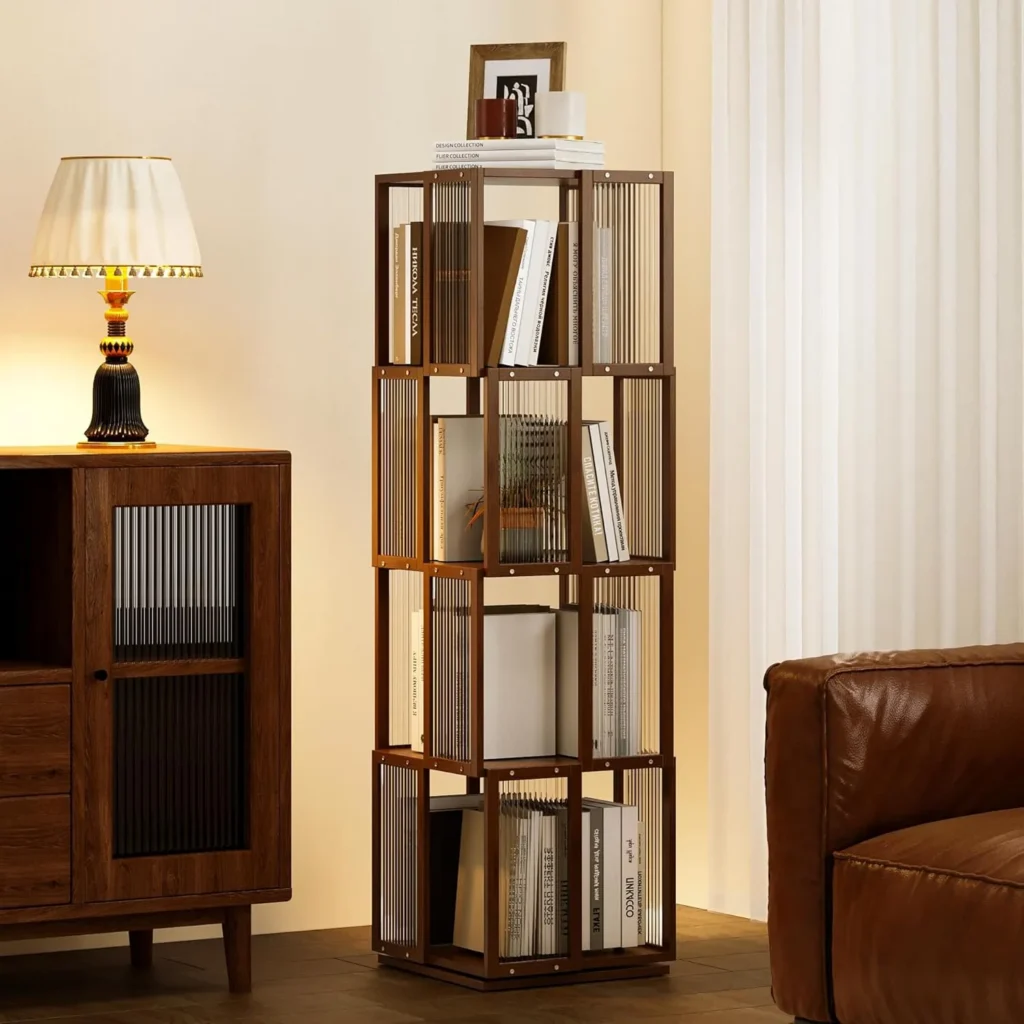 The BAMEOS orange 4-tier rotating bookcase accenting a minimalist living room, paired with black furniture to highlight the unique texture of bamboo and the clarity of modern acrylic.