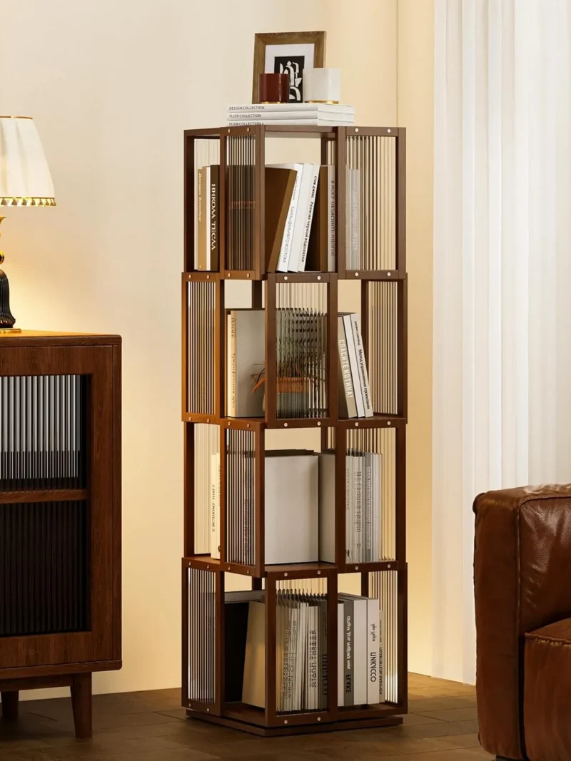 The BAMEOS orange 4-tier rotating bookcase accenting a minimalist living room, paired with black furniture to highlight the unique texture of bamboo and the clarity of modern acrylic.
